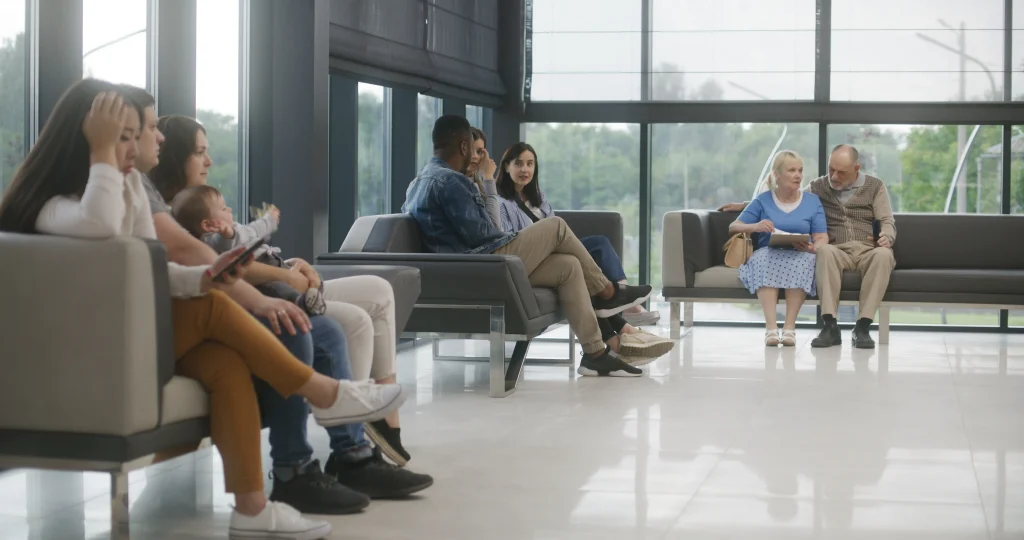 Clients seated in a modern real estate office lounge